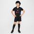 Kid wearing official Puma Barcelona away kit 2024-25 kid in black with red and blue details